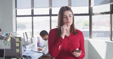 Businesswoman Contemplating Solutions in Modern Office