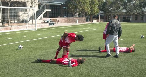 High school soccer team practicing on sunny field