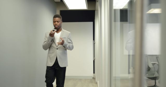 Businessman Taking Voice Command Technology in Modern Office Hallway - Download Free Stock Images Pikwizard.com