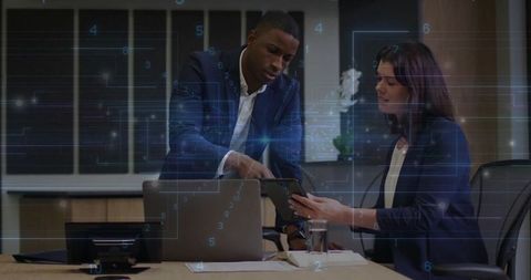 Business Team Collaborating on Digital Presentation in Office