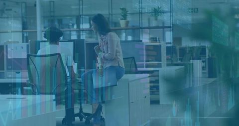 Colleagues analyzing data in modern open-plan office