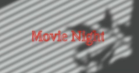 Movie night text projecting on blinds with diagonal shadow stripes and blurred silhouette