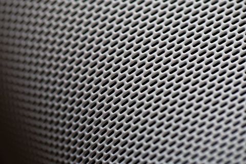 Close-up of gray speaker grill texture