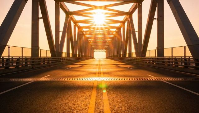 Sunburst Lighting Long Empty Steel Truss Bridge With Dramatic Leading Lines Golden Hour