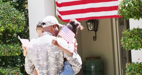 African American Soldier Homecoming with Children Holding Flags