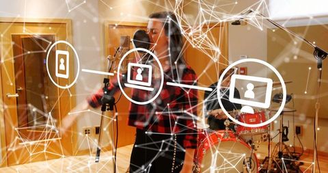 Singing vocalist recording in studio with digital network overlay and band collaboration