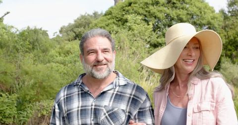 Senior Couple Enjoying a Nature Walk Amidst Greenery
