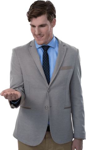 Smiling businessman in suit gesturing with open hand on transparent background