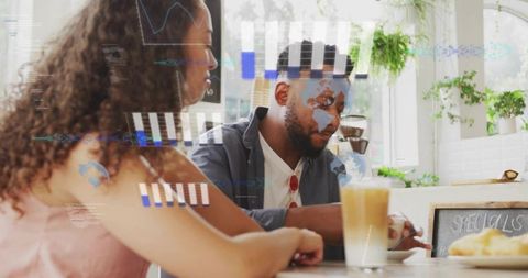 Couple sipping latte and leaning in for relaxed conversation in bright cafe
