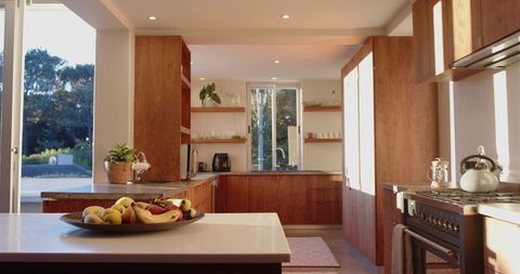 Bright modern kitchen with white countertop and wooden cabinets