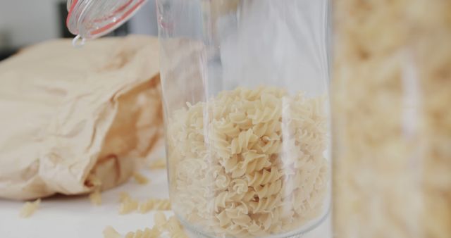 Dry Fusilli Pasta Pouring Into Jar for Kitchen Storage - Download Free Stock Images Pikwizard.com