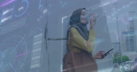 Businesswoman in Hijab Analyzing Data with Modern Technology Overlay