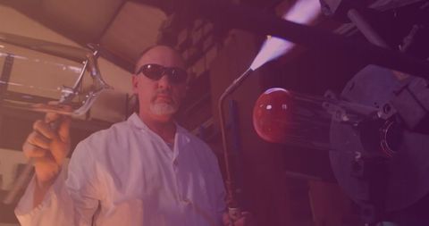 Skilled Glassblower Shaping Molten Glass in Artisan Workshop