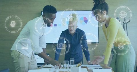 Diverse business team collaborating around table with data overlays and analytics display