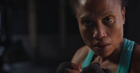Determined female athlete intense boxing training focus