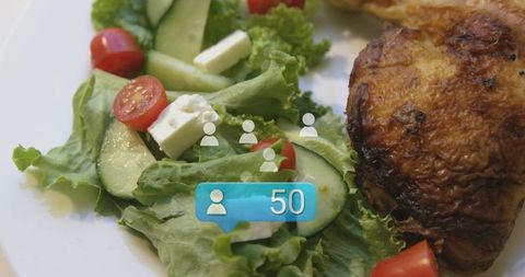 Grilled chicken thigh with fresh greek salad and social notification badge 50 closeup