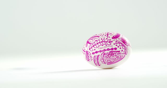 High-quality photo of a single Easter egg decorated with intricate purple patterns. Perfect for use in holiday cards, craft tutorials, Easter-themed articles, and festive social media posts.