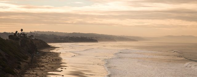 Golden Sunset Over Serene Beach with Gentle Waves - Download Free Stock Photos Pikwizard.com