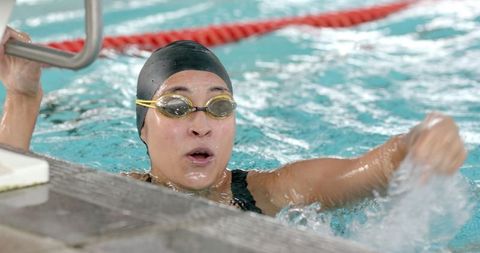 Female Swimmer Celebrating After Competitive Finish in Pool