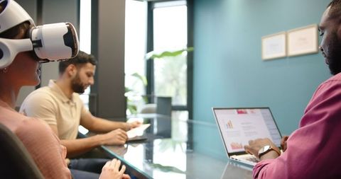Woman Uses VR Headset in Modern Office Meeting
