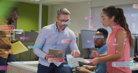 Collaborating team analyzing digital data with augmented reality overlays in modern office