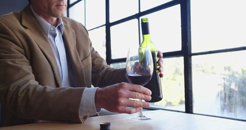 Businessman Tasting Red Wine by Sunlit Office Window - Download Free Stock Images Pikwizard.com