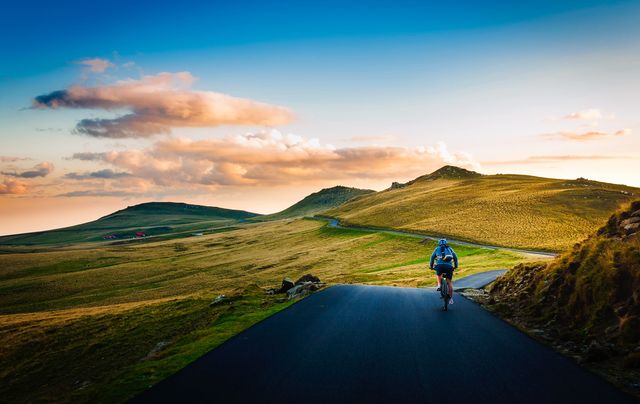 Cyclist Riding Through Mountain Landscape at Sunset - Download Free Stock Photos Pikwizard.com