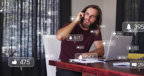 Man Engaging in Social Media with Smartphone and Laptop