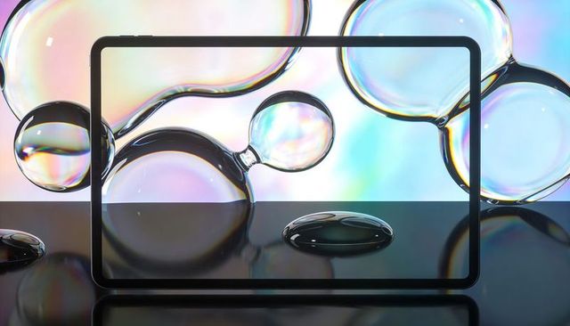 Iridescent Bubble Orbs Framing Thin Tablet Bezel Over Glossy Black Surface Pastel Gradient