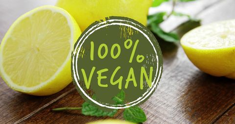 100 percent vegan text overlay on fresh lemons in rustic setting