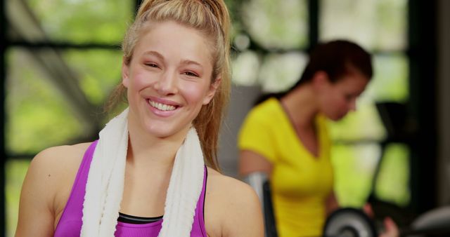 Smiling Woman at Gym with Workout Towel around Neck - Download Free Stock Images Pikwizard.com