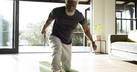 Senior Man Practicing Home Yoga for Health and Wellness