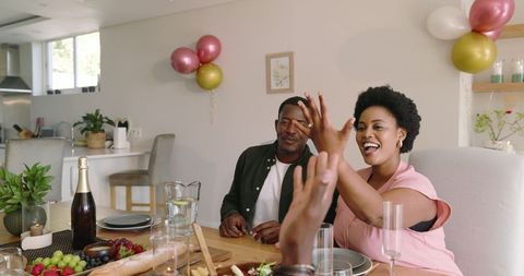 Friends sharing laughter at casual dining gathering