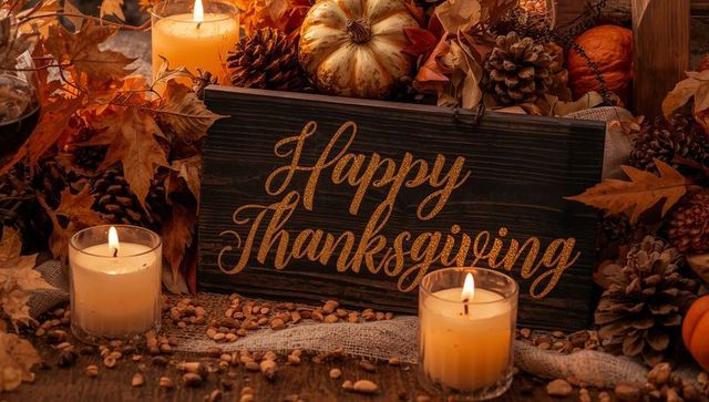 Rustic happy thanksgiving plaque with lit candles, pumpkins, pinecones, cozy autumn tablescape