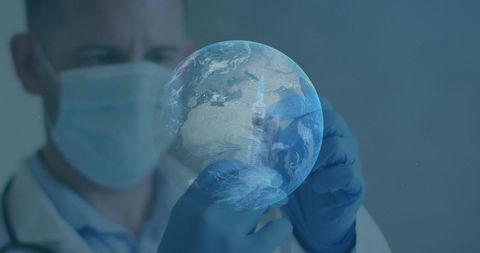 Doctor injecting syringe into digital globe for global health concept