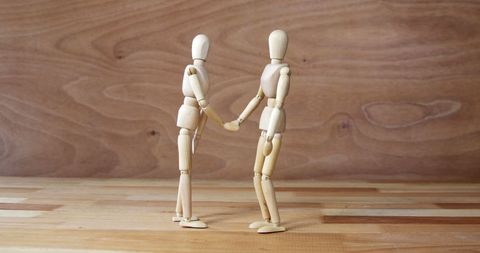 Wooden Artist Mannequins Shaking Hands with Wooden Background - Download Free Stock Images Pikwizard.com