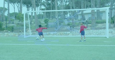 Children Playing Soccer Outdoors near Goalpost