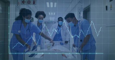 Medical team pushing patient through hospital corridor