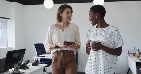 Professional women engaging in office collaboration