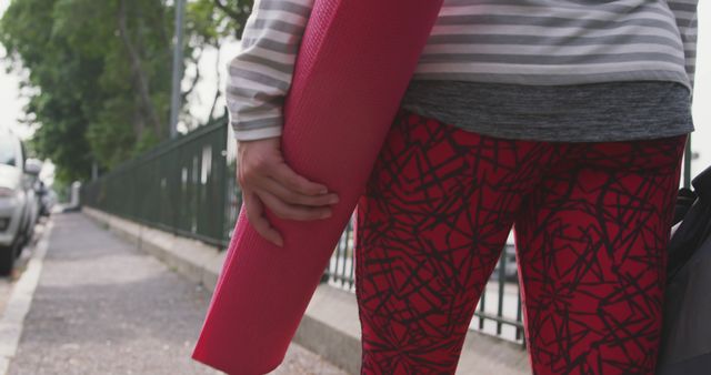 Person Holding Yoga Mat Wearing Red Printed Leggings Outdoor - Download Free Stock Images Pikwizard.com