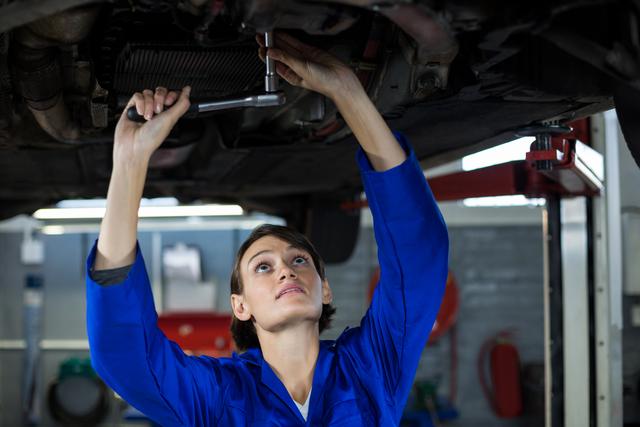 Female mechanic servicing a car - Download Free Stock Photos Pikwizard.com