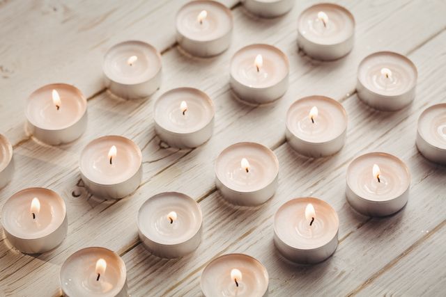 Candles burning on wooden table during christmas time