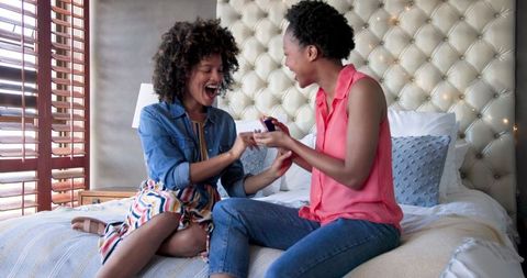 Two Happy Women Bonding on Bedroom Bed Understanding Friendship