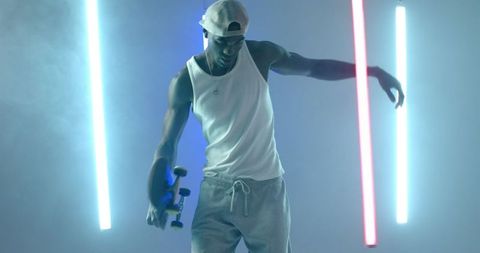 Dynamic skateboarder in neon-lit studio setting