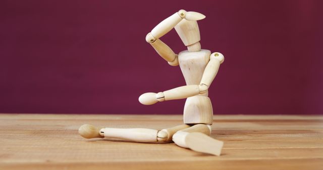 Wooden Mannequin Posing on Wooden Surface Against Purple Background - Download Free Stock Images Pikwizard.com