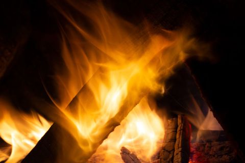 Close-Up of Vibrant Flames and Burning Logs in Fireplace