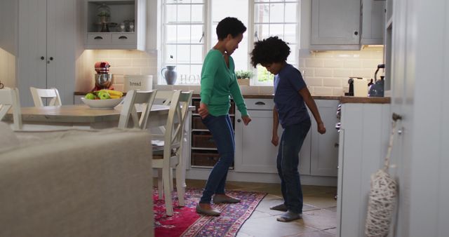 Mother and Son Dancing Playfully in Kitchen - Download Free Stock Images Pikwizard.com