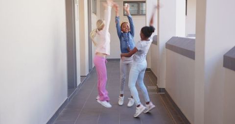 Joyful School Corridors: Girls Laughing and Jumping in Unison