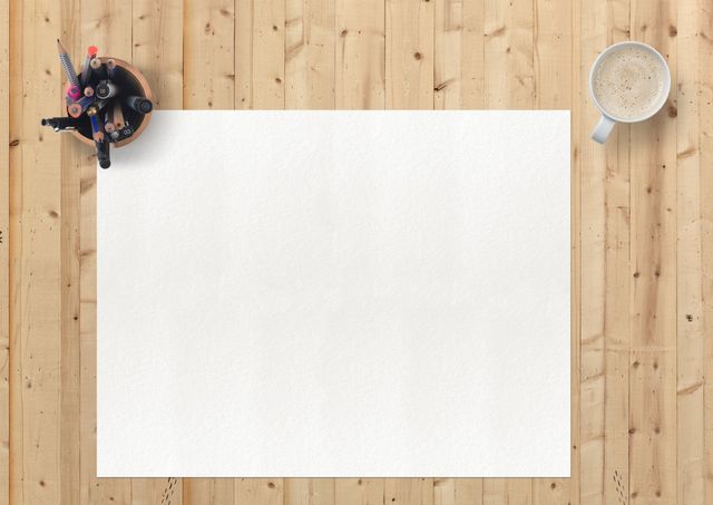 Blank sheet of paper placed on a wooden desk seen from above, surrounded by a cup of coffee and a holder containing various stationery items. Ideal for illustrating productivity, creativity, office settings, or promoting office supplies. Could also be used as a template for adding text or graphics without distractions.