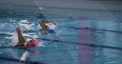 Competitive swimmers performing backstroke in indoor pool lanes